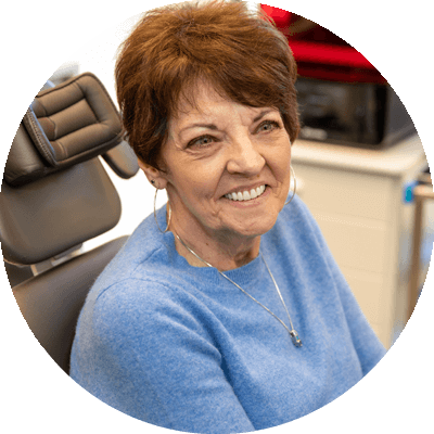 dental implant patient in chair smiling