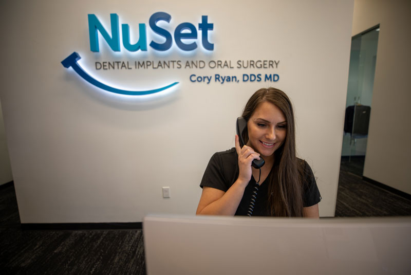 front office assistant answering phone calls_atnuset dental implant center