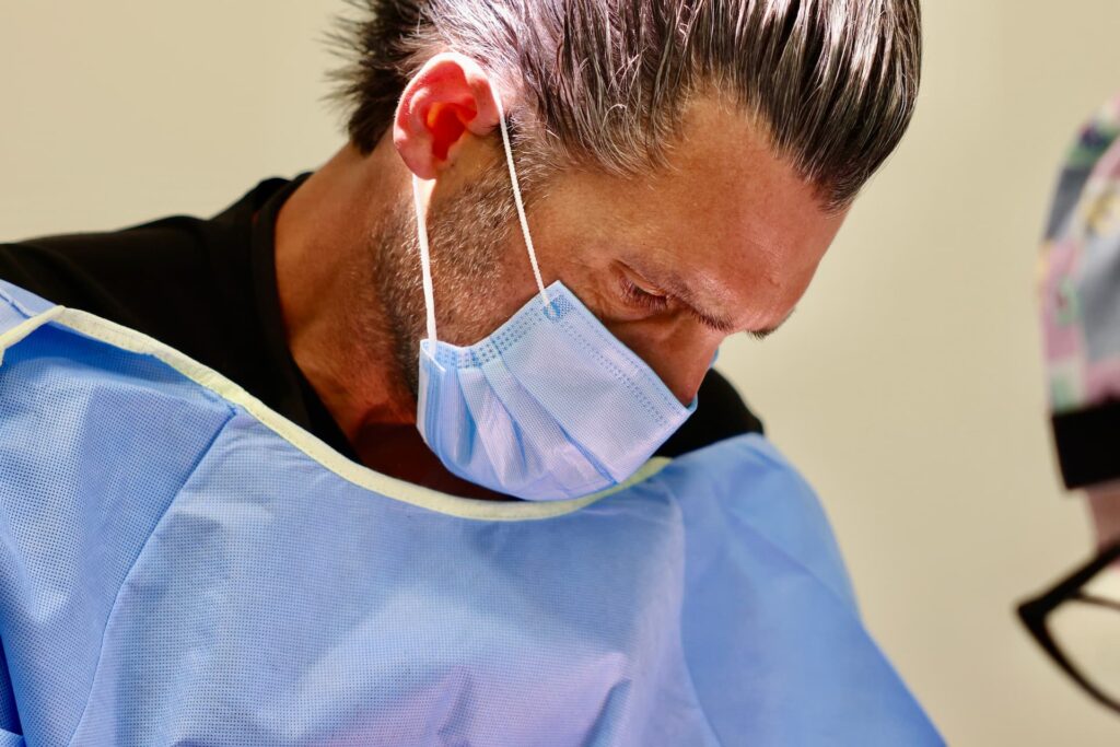 Dr. Cory Ryan examining dental patient after surgery